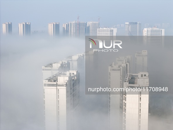 Buildings and real estate projects are seen in advection fog in Yantai, Shandong province, China, on October 26, 2024. 