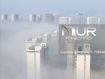 Buildings and real estate projects are seen in advection fog in Yantai, Shandong province, China, on October 26, 2024. (