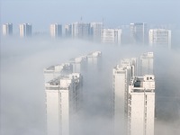 Buildings and real estate projects are seen in advection fog in Yantai, Shandong province, China, on October 26, 2024. (