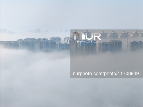 Buildings and real estate projects are seen in advection fog in Yantai, Shandong province, China, on October 26, 2024. 