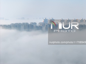 Buildings and real estate projects are seen in advection fog in Yantai, Shandong province, China, on October 26, 2024. (