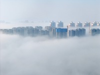 Buildings and real estate projects are seen in advection fog in Yantai, Shandong province, China, on October 26, 2024. (