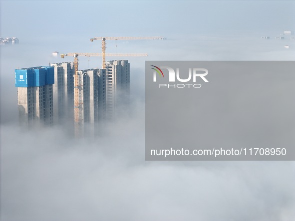 Buildings and real estate projects are seen in advection fog in Yantai, Shandong province, China, on October 26, 2024. 