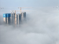 Buildings and real estate projects are seen in advection fog in Yantai, Shandong province, China, on October 26, 2024. (