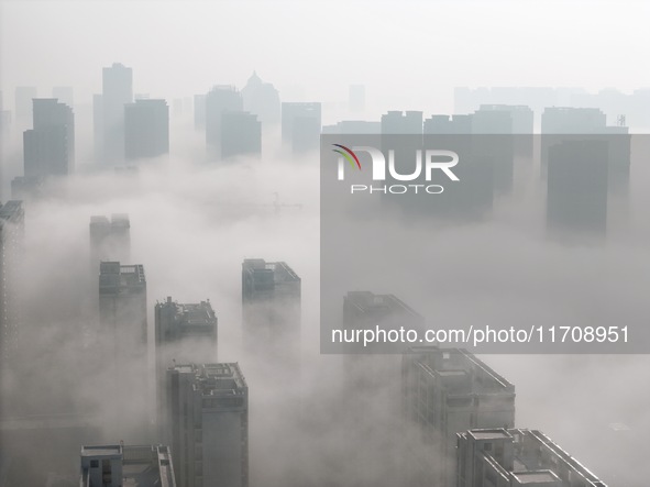 Buildings and real estate projects are seen in advection fog in Yantai, Shandong province, China, on October 26, 2024. 