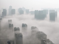 Buildings and real estate projects are seen in advection fog in Yantai, Shandong province, China, on October 26, 2024. (