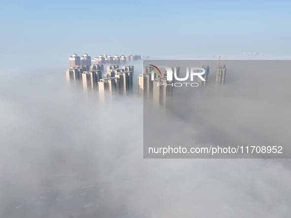 Buildings and real estate projects are seen in advection fog in Yantai, Shandong province, China, on October 26, 2024. 