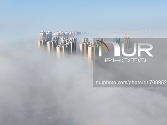 Buildings and real estate projects are seen in advection fog in Yantai, Shandong province, China, on October 26, 2024. (