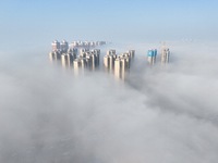 Buildings and real estate projects are seen in advection fog in Yantai, Shandong province, China, on October 26, 2024. (