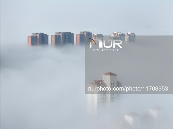 Buildings and real estate projects are seen in advection fog in Yantai, Shandong province, China, on October 26, 2024. 