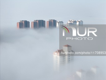 Buildings and real estate projects are seen in advection fog in Yantai, Shandong province, China, on October 26, 2024. (