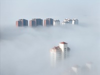 Buildings and real estate projects are seen in advection fog in Yantai, Shandong province, China, on October 26, 2024. (