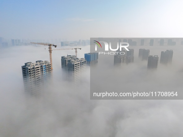 Buildings and real estate projects are seen in advection fog in Yantai, Shandong province, China, on October 26, 2024. 