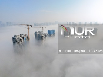 Buildings and real estate projects are seen in advection fog in Yantai, Shandong province, China, on October 26, 2024. (