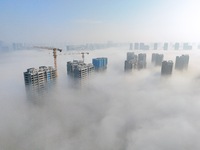 Buildings and real estate projects are seen in advection fog in Yantai, Shandong province, China, on October 26, 2024. (