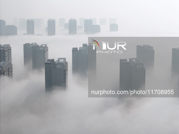 Buildings and real estate projects are seen in advection fog in Yantai, Shandong province, China, on October 26, 2024. 