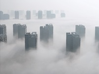 Buildings and real estate projects are seen in advection fog in Yantai, Shandong province, China, on October 26, 2024. (