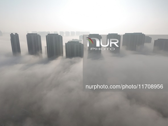 Buildings and real estate projects are seen in advection fog in Yantai, Shandong province, China, on October 26, 2024. 