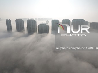 Buildings and real estate projects are seen in advection fog in Yantai, Shandong province, China, on October 26, 2024. (