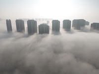 Buildings and real estate projects are seen in advection fog in Yantai, Shandong province, China, on October 26, 2024. (