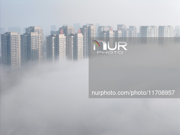 Buildings and real estate projects are seen in advection fog in Yantai, Shandong province, China, on October 26, 2024. 