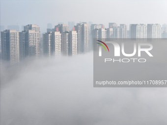 Buildings and real estate projects are seen in advection fog in Yantai, Shandong province, China, on October 26, 2024. (