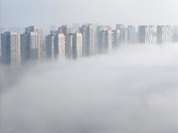 Buildings and real estate projects are seen in advection fog in Yantai, Shandong province, China, on October 26, 2024. (