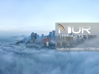 City buildings are seen in the clouds in the West Coast New Area of Qingdao, Shandong province, China, on October 26, 2024. (