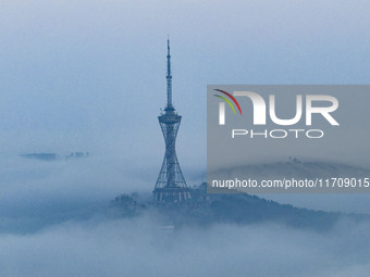 City buildings are seen in the clouds in the West Coast New Area of Qingdao, Shandong province, China, on October 26, 2024. (