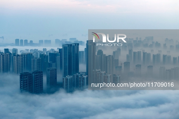 City buildings are seen in the clouds in the West Coast New Area of Qingdao, Shandong province, China, on October 26, 2024. 