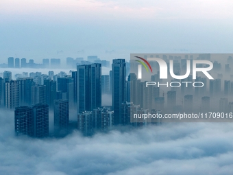 City buildings are seen in the clouds in the West Coast New Area of Qingdao, Shandong province, China, on October 26, 2024. (