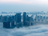 City buildings are seen in the clouds in the West Coast New Area of Qingdao, Shandong province, China, on October 26, 2024. (