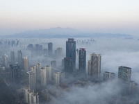 City buildings are seen in the clouds in the West Coast New Area of Qingdao, Shandong province, China, on October 26, 2024. (