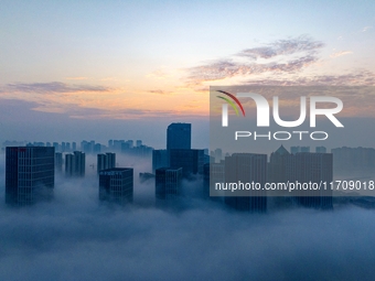 City buildings are seen in the clouds in the West Coast New Area of Qingdao, Shandong province, China, on October 26, 2024. (