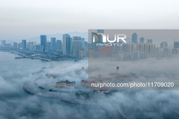 City buildings are seen in the clouds in the West Coast New Area of Qingdao, Shandong province, China, on October 26, 2024. 