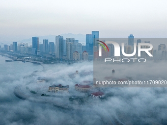 City buildings are seen in the clouds in the West Coast New Area of Qingdao, Shandong province, China, on October 26, 2024. (