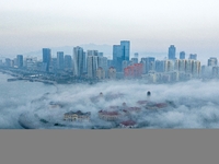 City buildings are seen in the clouds in the West Coast New Area of Qingdao, Shandong province, China, on October 26, 2024. (