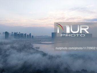 City buildings are seen in the clouds in the West Coast New Area of Qingdao, Shandong province, China, on October 26, 2024. (