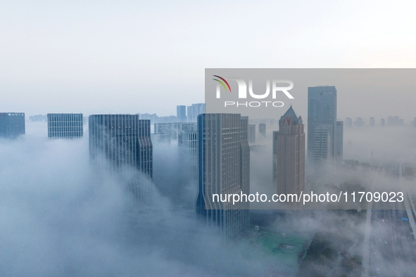 City buildings are seen in the clouds in the West Coast New Area of Qingdao, Shandong province, China, on October 26, 2024. 