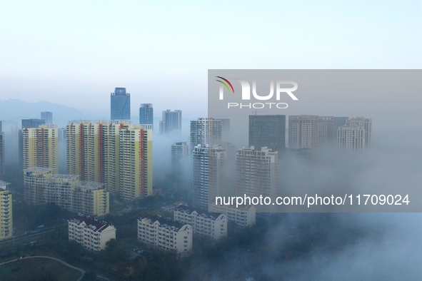 City buildings are seen in the clouds in the West Coast New Area of Qingdao, Shandong province, China, on October 26, 2024. 