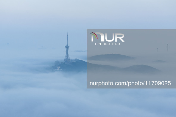 City buildings are seen in the clouds in the West Coast New Area of Qingdao, Shandong province, China, on October 26, 2024. 