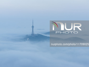 City buildings are seen in the clouds in the West Coast New Area of Qingdao, Shandong province, China, on October 26, 2024. (