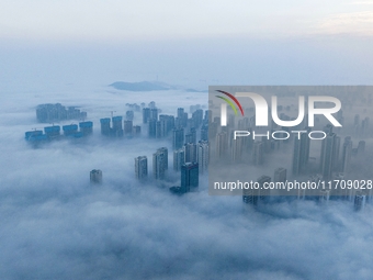 City buildings are seen in the clouds in the West Coast New Area of Qingdao, Shandong province, China, on October 26, 2024. (