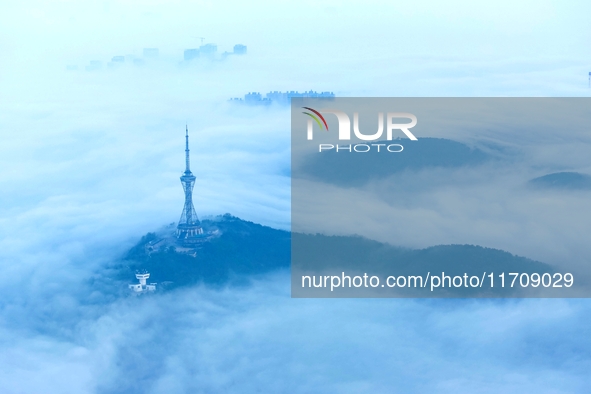 City buildings are seen in the clouds in the West Coast New Area of Qingdao, Shandong province, China, on October 26, 2024. 