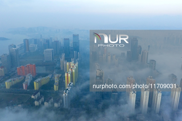 City buildings are seen in the clouds in the West Coast New Area of Qingdao, Shandong province, China, on October 26, 2024. 