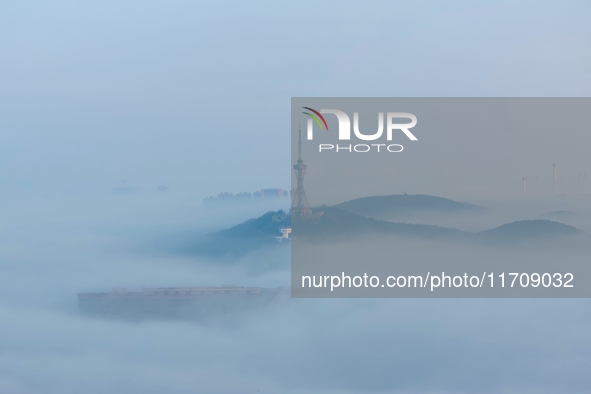 City buildings are seen in the clouds in the West Coast New Area of Qingdao, Shandong province, China, on October 26, 2024. 