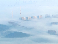 City buildings are seen in the clouds in the West Coast New Area of Qingdao, Shandong province, China, on October 26, 2024. (