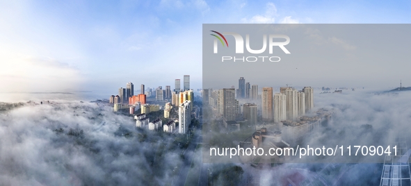 City buildings are seen in the clouds in the West Coast New Area of Qingdao, Shandong province, China, on October 26, 2024. 