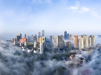 City buildings are seen in the clouds in the West Coast New Area of Qingdao, Shandong province, China, on October 26, 2024. (