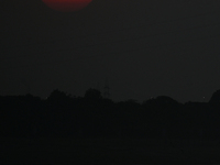 Visitors are silhouetted against the setting sun as they ride a boat during sunset at Sangam, the confluence of the rivers Ganges, Yamuna, a...